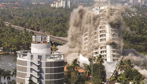 A high-rise residential building is demolished with controlled blasting in Kochi yesterday.