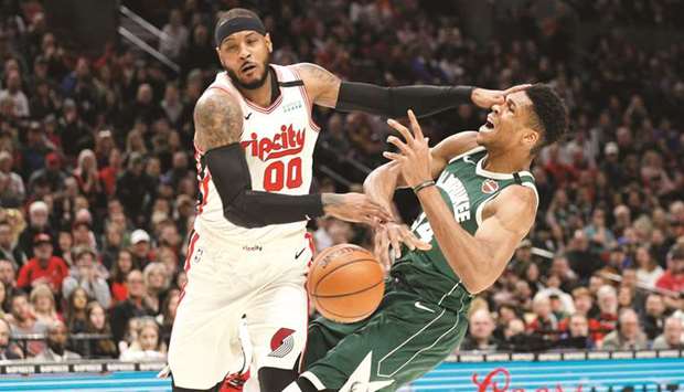 Milwaukee Bucks power forward Giannis Antetokounmpo (right) is fouled by Portland Trail Blazers power forward Carmelo Anthony while driving to the basket during the first half at Moda Center. PICTURE: USA TODAY Sports