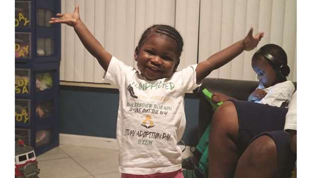 Two-year-old Zariah Senior smiles in her Boynton Beach home on Dec 9, 2019. She is wearing the same shirt she wore on the day she and her siblings were adopted out of foster care by Monica Peoples and Michelle Senior. (Kristina Webb/Palm Beach Post/TNS)