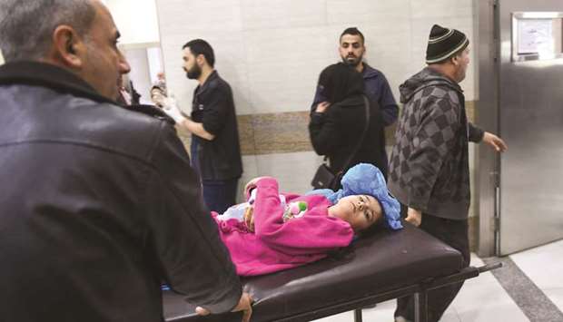 A wounded girl is rushed into the emergency at the University hospital in a government-held neighbourhood yesterday, following reported rebel fire on government-held parts of the northern city of Aleppo.