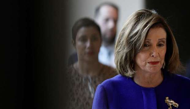 US House Speaker Nancy Pelosi (D-CA) walks to the House of Representatives Television Studio with staff members before delivering remarks at a news conference at the US Capitol in Washington on January 9.