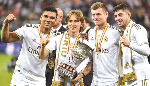(From left) Real Madridu2019s Casemiro, Luka Modric, Toni Kroos and Federico Valverde pose with the trophy after winning the Spanish Super Cup final against Atletico Madrid in Jeddah, Saudi Arabia, on Sunday. (AFP)