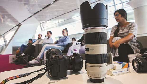 Camera enthusiasts attend the digital photography course at QNL.