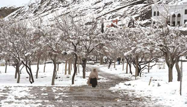 A woman walks after heavy snowfall in Quetta.