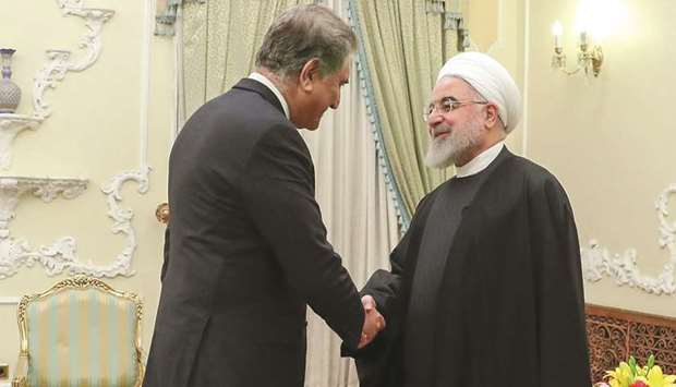 A handout picture provided by the official website of the Iranian Presidency shows Foreign Minister Qureshi with Iranian President Rouhani in Tehran on Sunday.