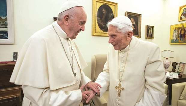 This file handout picture taken and released by Vatican Media on December 21, 2018, shows Pope Francis with predecessor Benedict XVI at the Vatican.