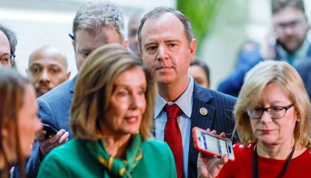 House Intelligence Committee chairman Adam Schiff (D-CA) and House Speaker Nancy Pelosi (D-CA) are followed by reporters after a House Democratic Caucus meeting at the US Capitol in Washington.