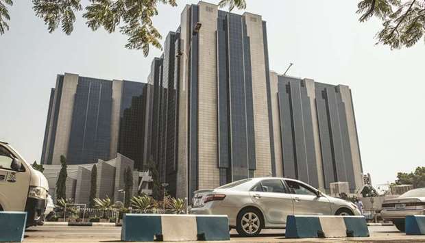 Vehicles drive past the headquarters of the Nigerian central bank in Abuja on January 10. Nigeriau2019s $400bn economy dominates the region and accounts for more than two-thirds of the gross domestic product of Ecowas, about ten times bigger than Ivory Coast, the largest among the CFA franc nations.