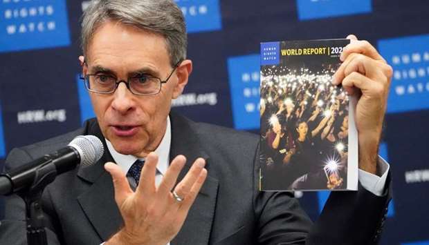 Kenneth Roth, the Executive Director of Human Rights Watch holds up their World Report 2020 at the United Nations in the Manhattan borough of New York City, New York