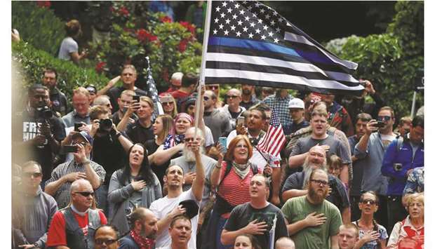 Conservative protesters recite the National Anthem during competing demonstrations in Portland, Oregon, US, in this June 4, 2017, photograph.