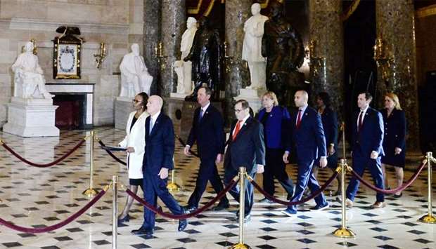 Secretary of the Senate Irving, House Clerk Johnson and impeachment managers walk through Statuary Hall with the articles of impeachment in in Washington