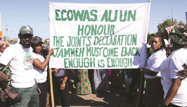 Demonstrators hold a banner during a demonstration in Sukuta yesterday, demanding the return of Yahya Jammeh.