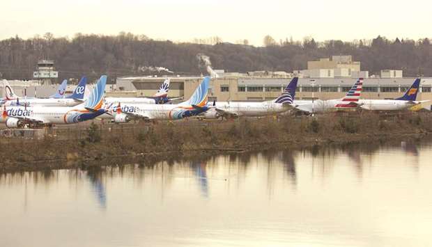 Grounded Boeing 737 MAX airplanes are seen in a parking lot along the Duwamish River near Boeing Field in Seattle. A flight control sub-system, which wasnu2019t disclosed to airline flight crews, played a role in two fatal crashes that killed 346 people and prompted a worldwide grounding.