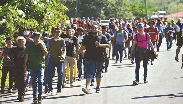 Honduran migrants walk to Puerto Barrios, in Izabal department, Guatemala, after breaking a police fence at the border crossing between Corinto, Honduras and Guatemala, on Wednesday.