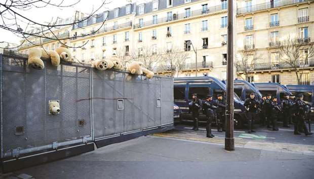 Giant teddy bears are seen on anti-riot fences, as riot mobile gendarmes stand at a crossroad of the avenue des Gobelins in Paris, yesterday on the 43rd day of nationwide multi-sector protests and strikes against the government pension reform.