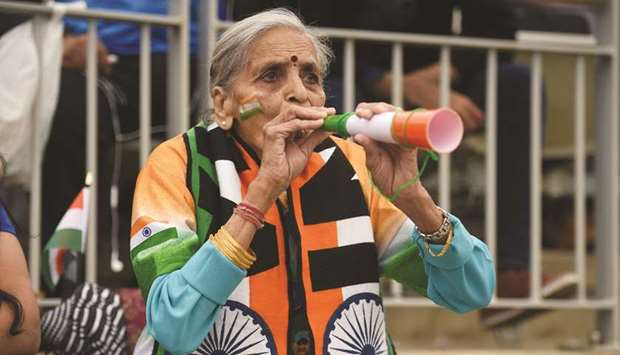 In this file photo taken on July 9, 2019, Charulata Patel is seen cheering on the Indian team during the 2019 Cricket World Cup first semi-final between India and New Zealand at Old Trafford in Manchester.