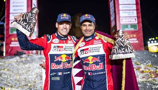 Qatar's Nasser Saleh al-Attiyah (right) and his French co-driver Mathieu Baumel pose with their runner-up trophies after the Dakar Rally 2020 in Qiddiya, Saudi Arabia, Friday. The defending champion won the final stage to see off the challenge from 13-time champion Stephane Peterhansel for the second spot. Spaniard Carlos Sainz won the title for the third time in his career