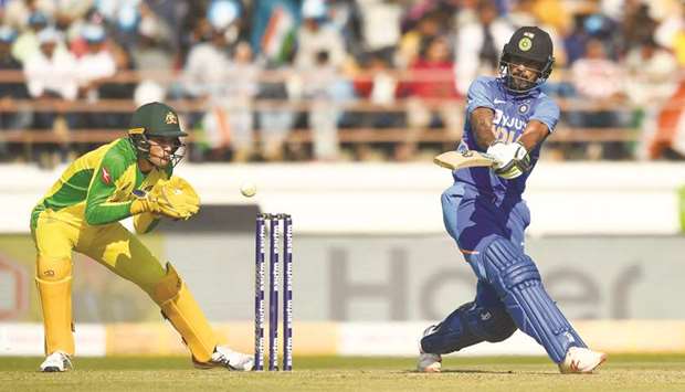 Shikhar Dhawan (right) plays a shot during the second ODI against Australia at Saurashtra Cricket Association Stadium in Rajkot yesterday. (AFP)
