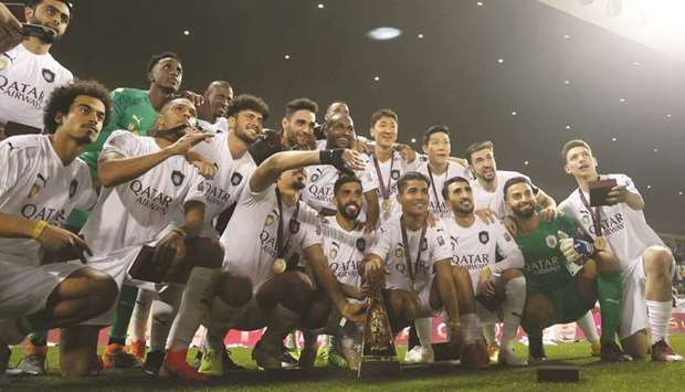 Al Sadd players pose with the Qatar Cup trophy after their 4-0 win over Al Duhail in the final yesterday. . PICTURE: Anas al-Samaraee and Shemeer Rashid