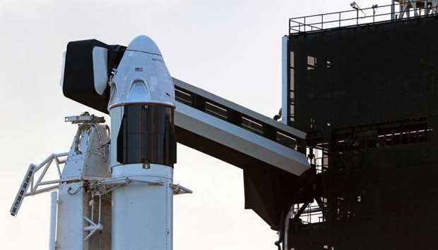 The SpaceX Crew Dragon sits atop a Falcon 9 booster rocket on Pad 39A at Kennedy Space Center before a scheduled in-flight abort test