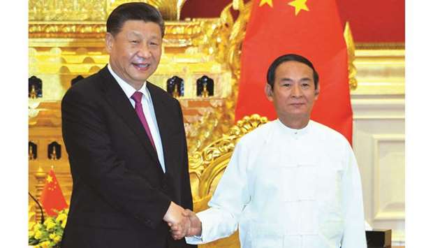 Chinese President Xi Jinping, left, and Myanmar President Win Myint shake hand during their meeting at the Presidential Palace in Naypyidaw yesterday.