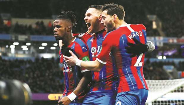 Crystal Palaceu2019s Wilfried Zaha celebrates with teammates after Manchester Cityu2019s Fernandinho scored an own goal yesterday. (Reuters)