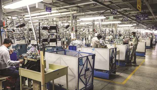 Employees operate machinery in the knitting section of an Interloop Ltd facility in Faisalabad. The UN projects Pakistanu2019s economy to grow by estimated 3.3% for 2019-20, is projected to slip to 2.1% next year, while Indian economy will grow by 5.7% in the current fiscal year and expects it to rise to 6.6% in the next.