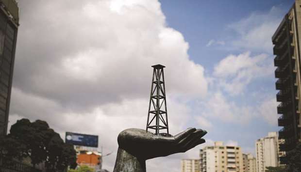 A sculpture is seen outside a building of Venezuelau2019s state oil company PDVSA in Caracas (file). The shrinking coffers mark a new low for Venezuela, where an economic crisis rooted in the collapse of its all-important oil industry has been exacerbated by wide-reaching US sanctions that have cut the nation off from international capital markets.