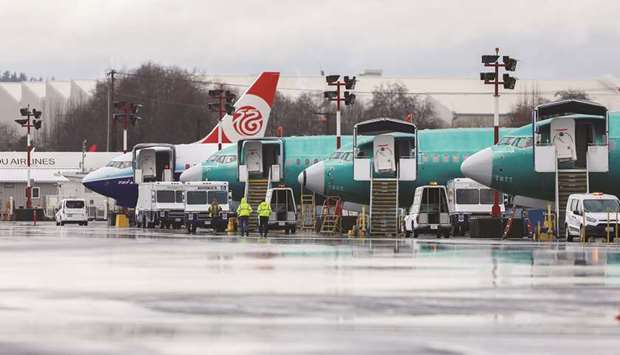 Several Boeing 737 MAX aircraft are seen parked outside the companyu2019s production facility in Renton, Washington. The 737 MAX is costing the plane-maker billions of dollars in losses.