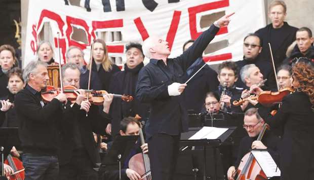 Conductor Michel Dietlin and members of the Paris Operau2019s orchestra play an improvised open-air concert outside the Opera Garnier to protest the governmentu2019s proposed pension reform.