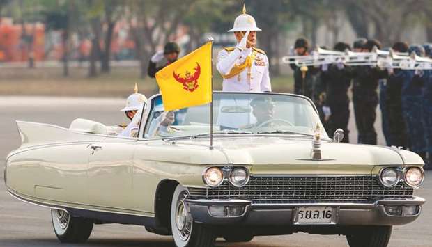 Thailandu2019s King Maha Vajiralongkorn accompanied by Queen Suthida (back left) and Princess Bajrakitiyabha (front left) stands to salute while inspecting military troops during a parade ceremony in Saraburi province yesterday.