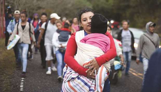 Honduran migrants walk in a caravan heading to the US, near Quezaltepeque, Chiquimula department, Guatemala, on Friday.