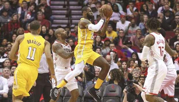 Los Angeles Lakers forward LeBron James (centre) passes the ball during the first quarter against the Houston Rockets at Toyota Center. PICTURE: USA TODAY Sports