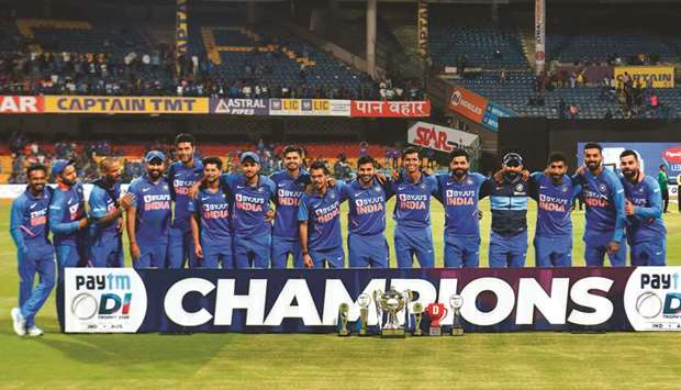 Team India pose with the trophy after winning the third and final ODI against Australia at the M. Chinnaswamy Stadium in Bengaluru yesterday. (AFP)