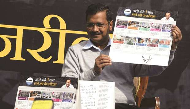 Delhi Chief Minister and Aam Admi Party (AAP) chief Arvind Kejriwal shows the u2018Kejriwal Ka Guarantee Cardu2019 (Kejriwalu2019s guarantee card) promising improvements on electricity, drinking water and women safety, ahead of Delhi assembly elections, in New Delhi yesterday.