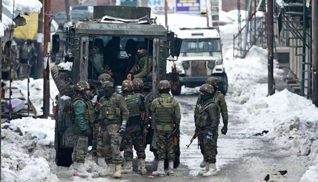 Indian army soldiers stand guard during a cordon and search operation following reports of the presence of three militants in Chadoora, Budgam district, on Saturday.