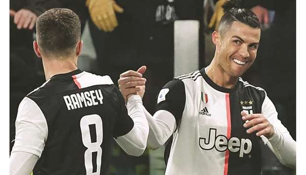 Juventusu2019 Cristiano Ronaldo (right) celebrates with teammate Aaron Ramsey after scoring against Parma during the Serie A match in Turin on Sunday. (AFP)