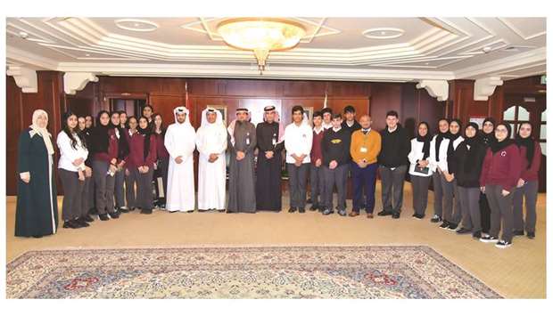QIIB chief executive officer Dr Abdulbasit Ahmed al-Shaibei and senior bank executives with the touring students of Qatar Academy.