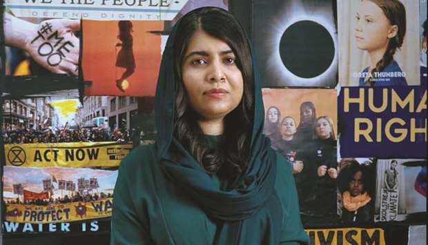 STANDING TALL: Malala Yousafzai standing in front of the Teen Vogue cover board.