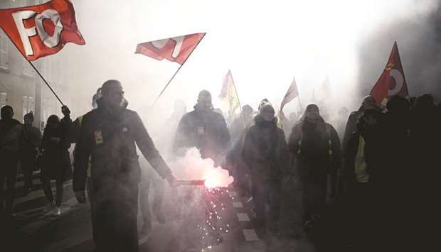 Protesters take part in a demonstration in Versailles against President Macron as part of a nationwide multi-sector strike against the French governmentu2019s pensions overhaul.