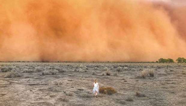 A child running towards a dust storm in Mullengudgery in New South Wales.