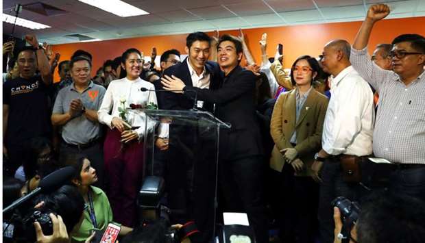 Thailand's opposition Future Forward Party leader Thanathorn Juangroongruangkit, Secretary general Piyabutr Saengkanokkul and party members celebrate during a news conference after Thailand's Constitutional Court ruled that key figures of the opposition Future Forward Party were not guilty of opposing the monarchy, at the party's headquarters in Bangkok.