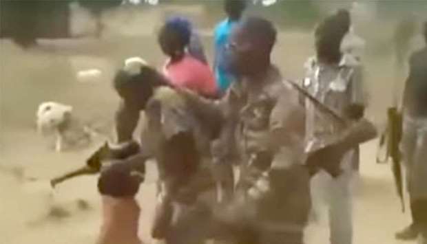 An image grab from a video that was shared widely on social media shows the women and children being led away by the soldiers.