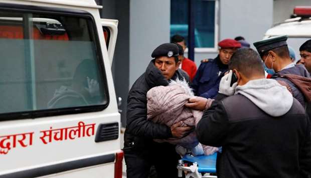 The body of a child who is among the eight Indian tourists who died due to suspected suffocation is being carried inside an ambulance while being taken for postmortem in Kathmandu.