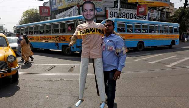 A demonstrator holds an effigy depicting billionaire jeweller Nirav Modi during a protest in Kolkata