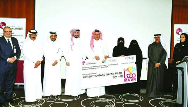Qatar Chamber officials hand over the ceremonial cheque to the winners in the presence of other dignitaries.