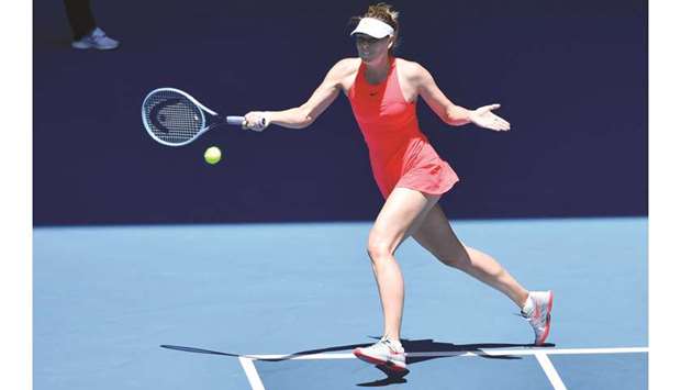 Russiau2019s Maria Sharapova hits a return against Croatiau2019s Donna Vekic during their singles match at the Australian Open in Melbourne yesterday. (AFP)