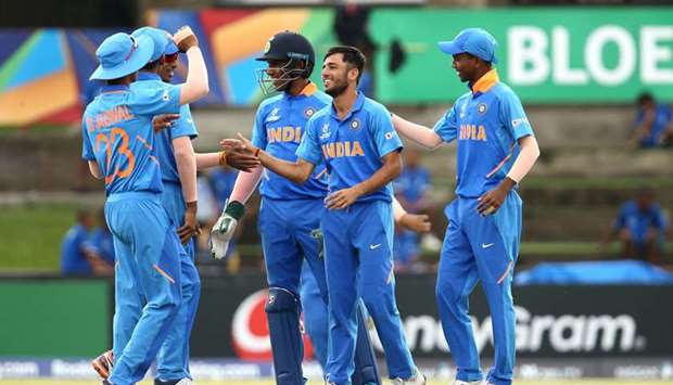 Ravi Bishnoi of India (second from right) celebrates a wicket with teammates during the ICC U19 World Cup Group A match against Japan at Mangaung Oval yesterday. (ICC)