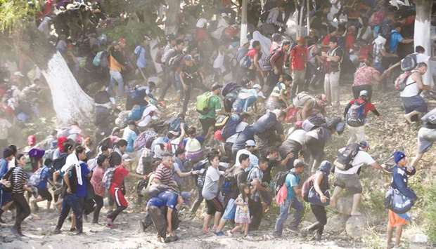 Central American migrants run after crossing the Suichate River, the natural border between Guatemala and Mexico, near Ciudad Hidalgo.