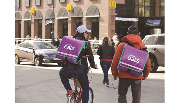 Workers for Uber Eats cycle and walk towards a McDonaldu2019s restaurant in Moscow. Having already dominated Africau2019s ride-hailing sector, Uber is trying to conquer the food delivery market by leveraging its massive fleet of drivers in the continentu2019s most developed economy and tracking popular food choices and destinations.